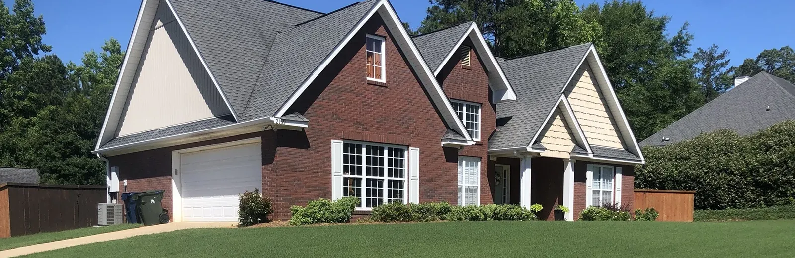 Red brick home with nice front lawn