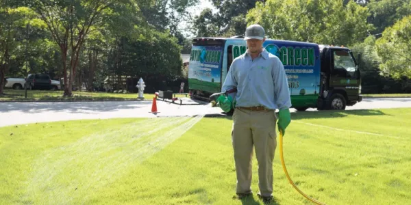 Envirogreen technician fertilizing the lawn